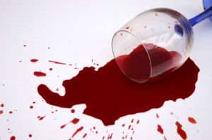 glass or red wine spilled on the floor
